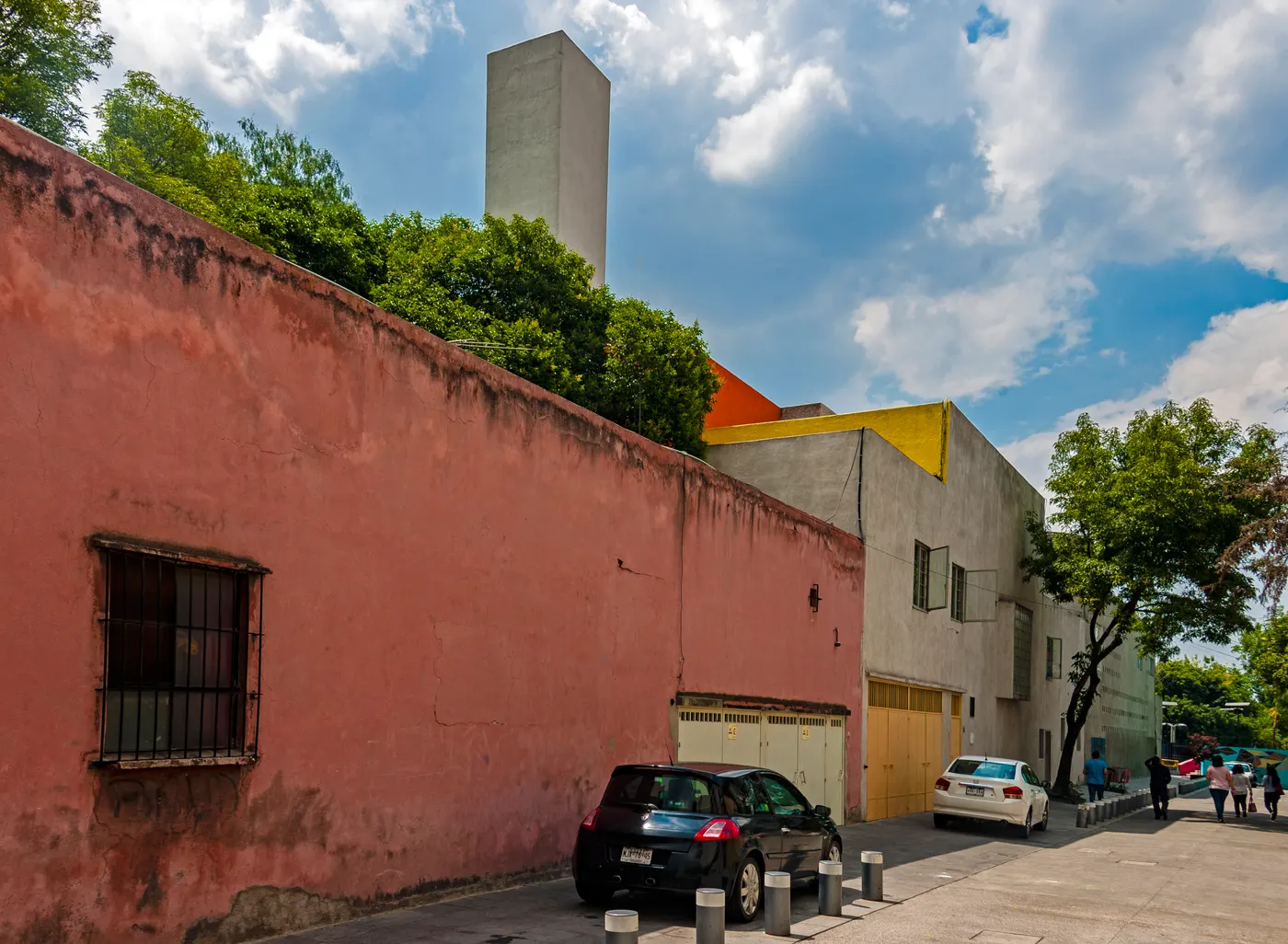 General Francisco Ramírez looking towards Casa Luis Barragán, its white water tower and yellow and orange corner above the street wall